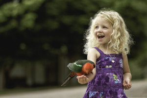 little girl with parrot at Pigeon Forge attraction for toddlers