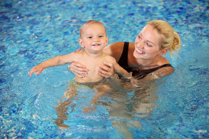 mother and baby swimming in Pigeon Forge cabins with indoor pool