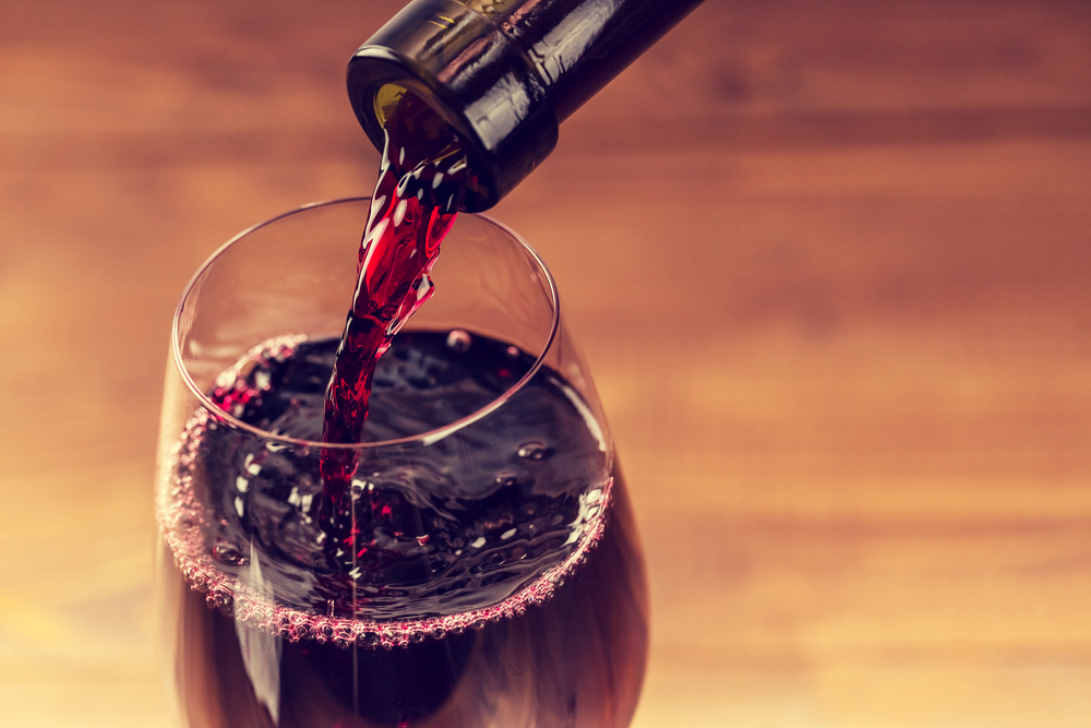 Red wine being poured into a glass.