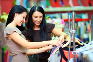 Two women shopping together for clothes.